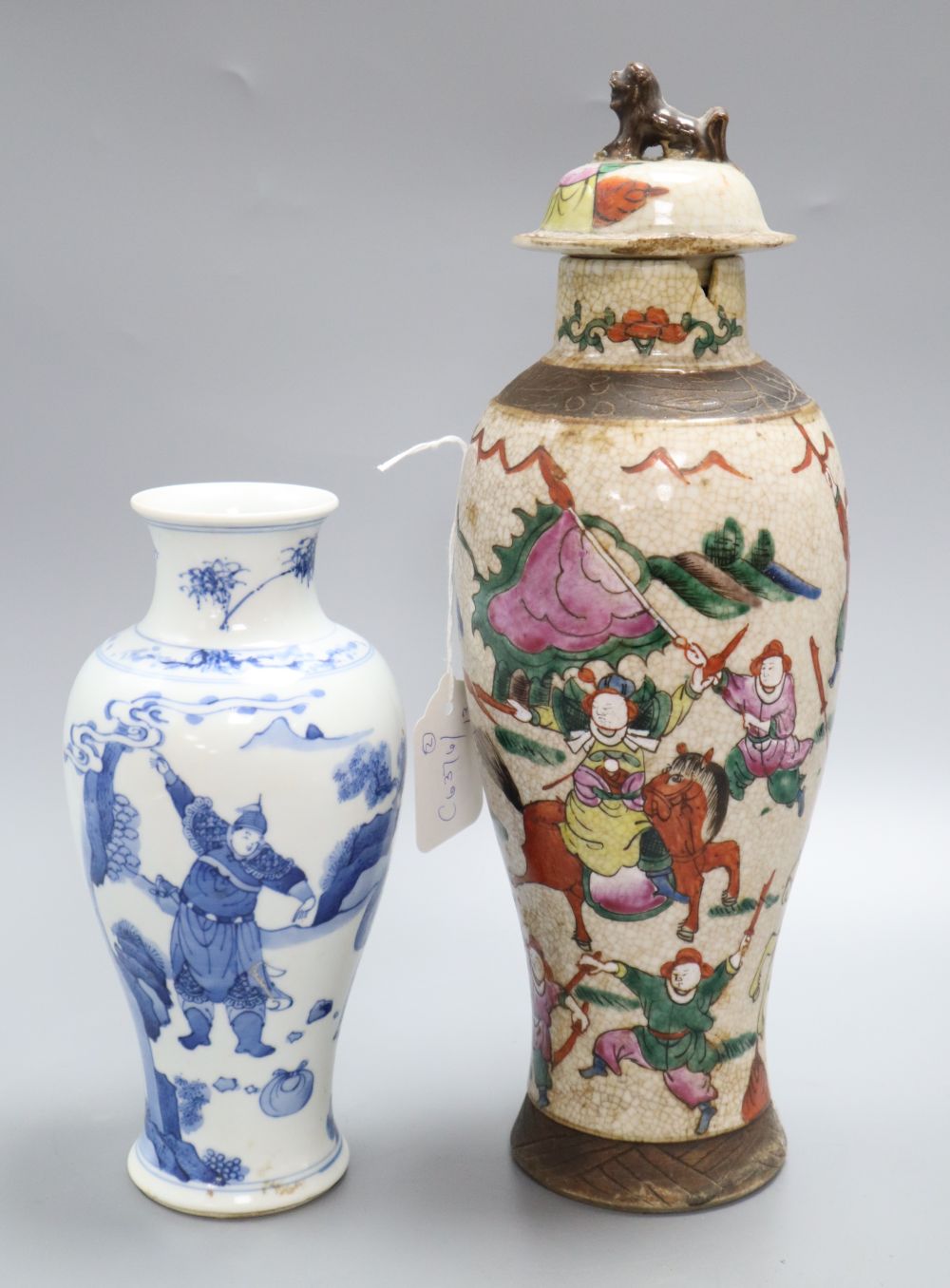 A Chinese famille rose crackleglaze vase and cover, together with a Chinese blue and white figural vase bearing Kangxi mark,
